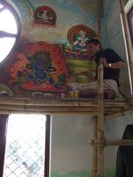Newari artist painting walls in Buddhist temple, Kathmandu Valley, Nepal