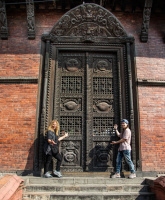 Some of our happy clients showing off a nice Newari style carved wooden door. 