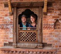 Tara and Ian inspecting a friend's recently made Newari window in a village. 